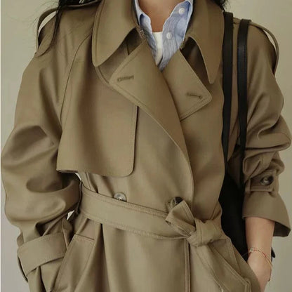 Stylish British style trench coat for women in beige with a belted waist and elegant collar