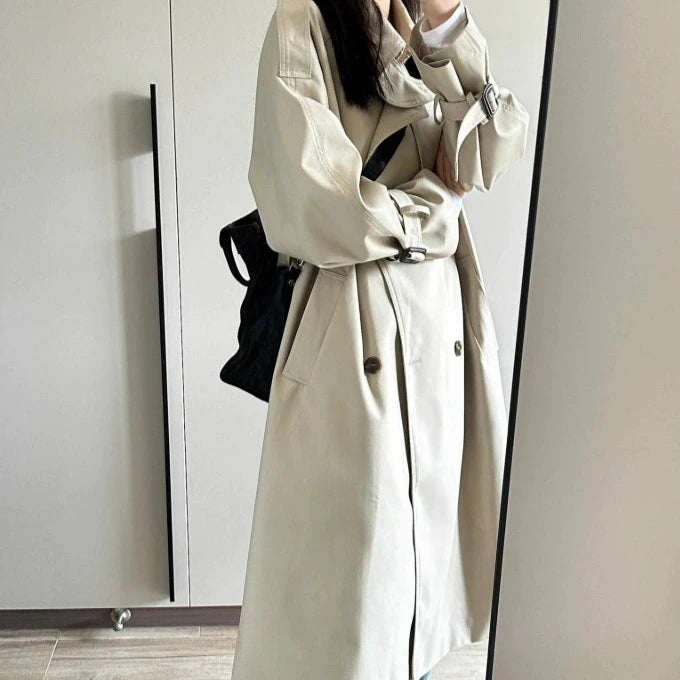 Elegant beige British style trench coat for women with spacious pockets and a relaxed fit