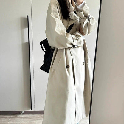 Elegant beige British style trench coat for women with spacious pockets and a relaxed fit