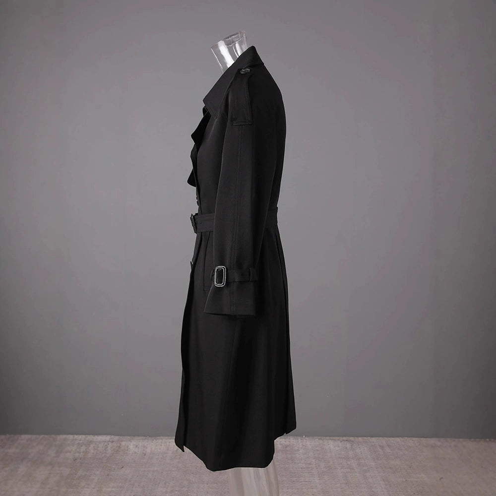 Side view of a black British style trench coat for women with a belted waist and classic silhouette