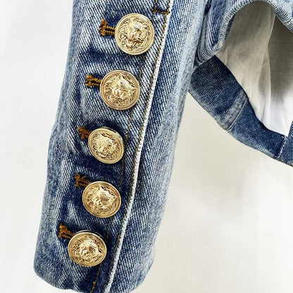 Close-up of women's belted denim jacket showcasing detailed gold buttons on the sleeve