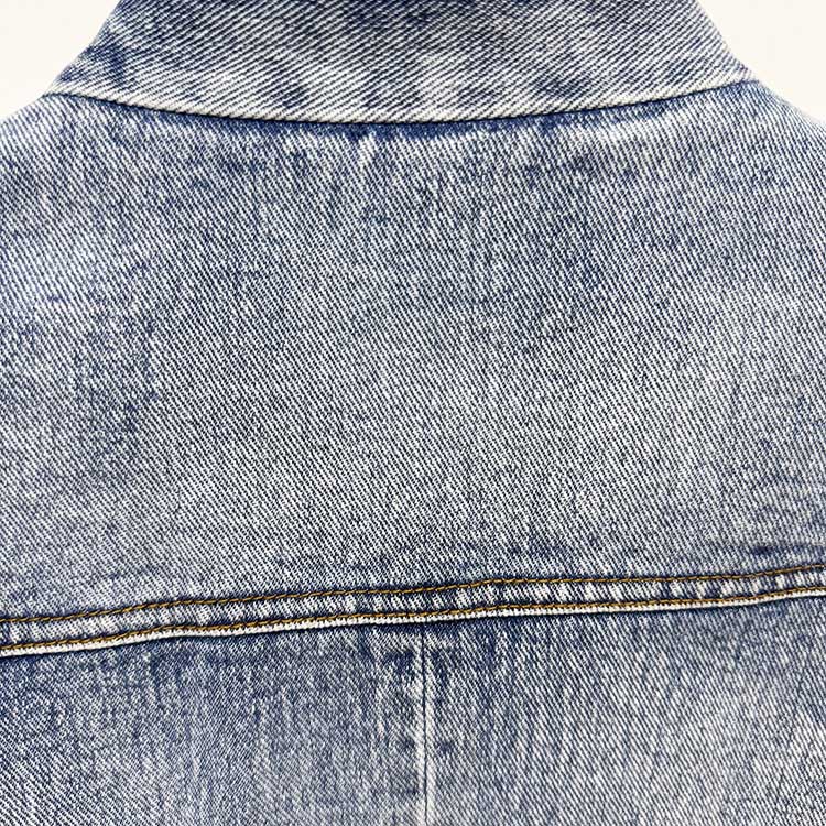 Back view of a stylish women's belted denim jacket in light blue wash, perfect for casual outfits