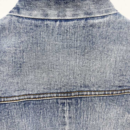 Back view of a stylish women's belted denim jacket in light blue wash, perfect for casual outfits