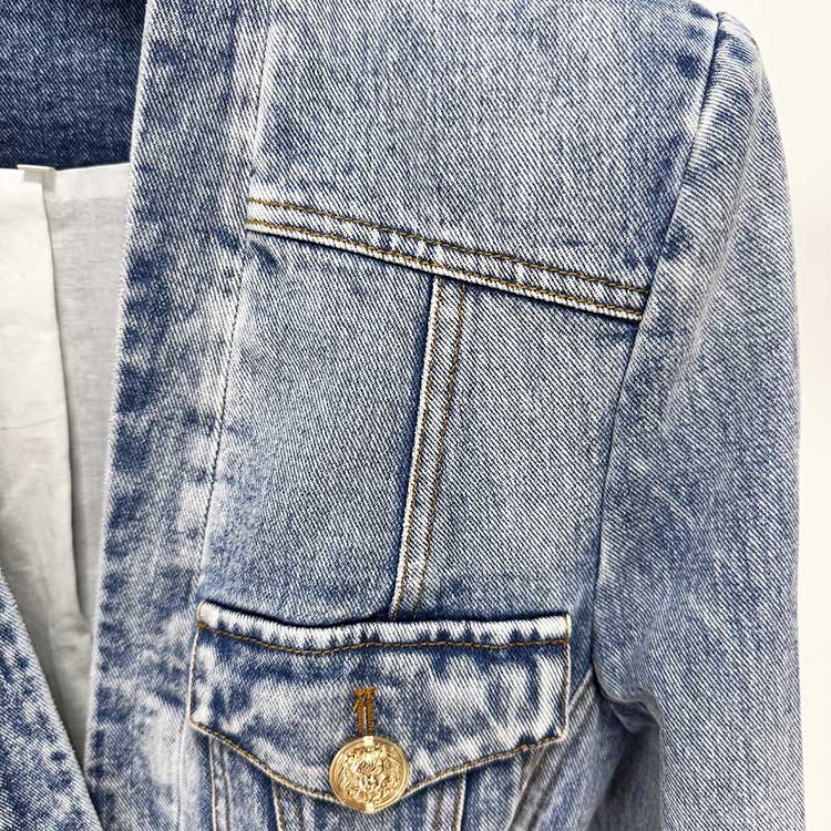 Close-up of women's belted denim jacket featuring stylish stitching and pocket details