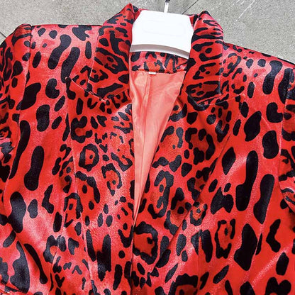 Close-up of a slim fit animal print suit for women in vibrant red and black with a sleek collar design