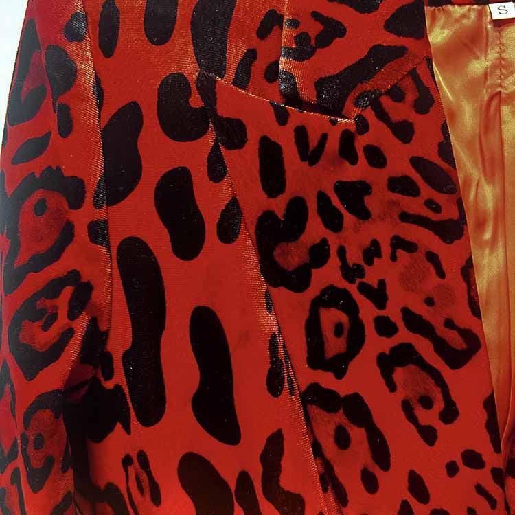 Close-up of slim fit animal print suit for women in striking red and black pattern