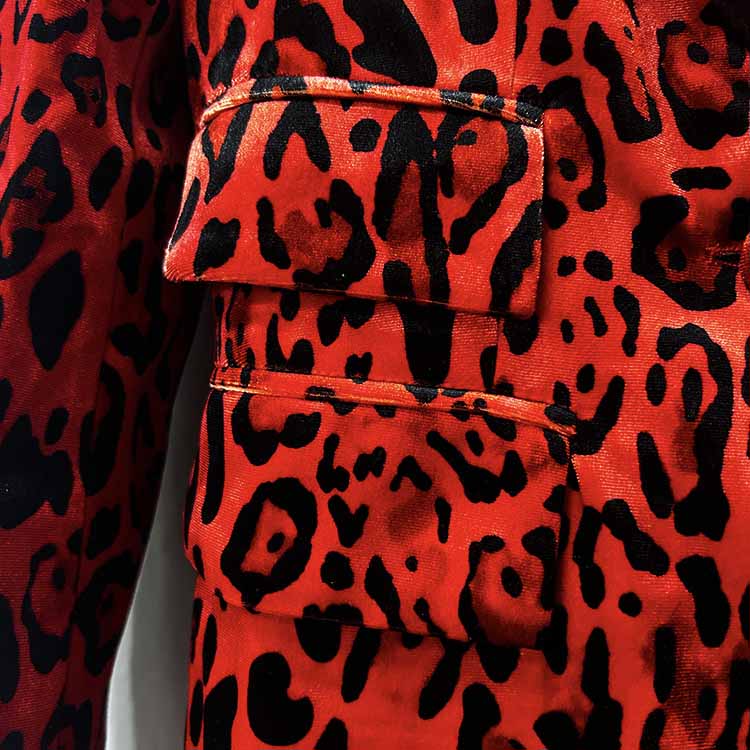 Close-up of a slim fit animal print suit for women featuring vibrant red and black patterns