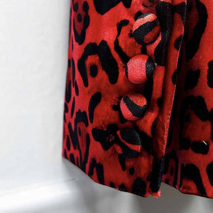 Close-up of a slim fit animal print suit for women featuring a vibrant red pattern and stylish buttons