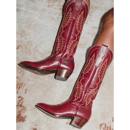 Women vintage cowboy boots in burgundy with intricate stitching for a classic Western look