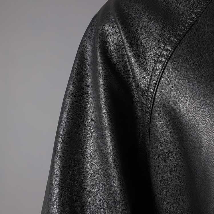 Close-up of a women's belted leather jacket with pockets showcasing soft, premium leather texture