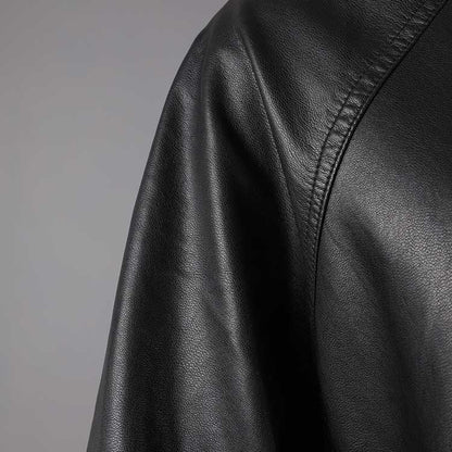 Close-up of a women's belted leather jacket with pockets showcasing soft, premium leather texture
