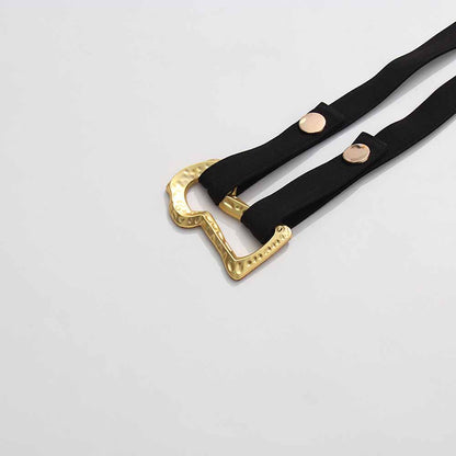 Belt detail of a women's black belted winter coat showcasing elegant gold buckle design