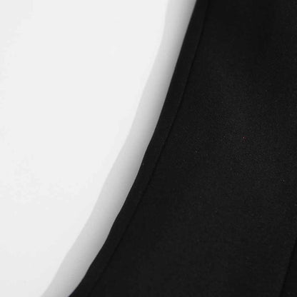 Close-up of the fabric detail on a women's black belted winter coat by sd-hk