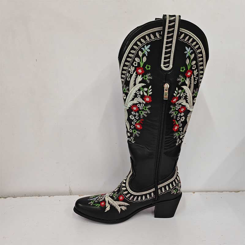 Stylish women's black embroidered cowboy boots with intricate floral designs and a low heel