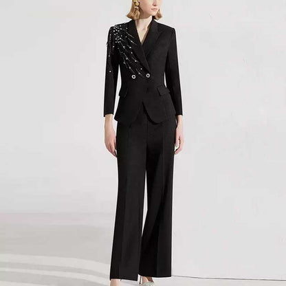 Stylish women's black formal pantsuit with unique detailing and modern fit for professional occasions