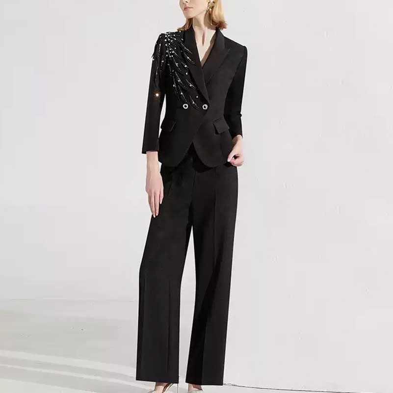Stylish women's black formal pantsuit with decorative embellishments on the blazer