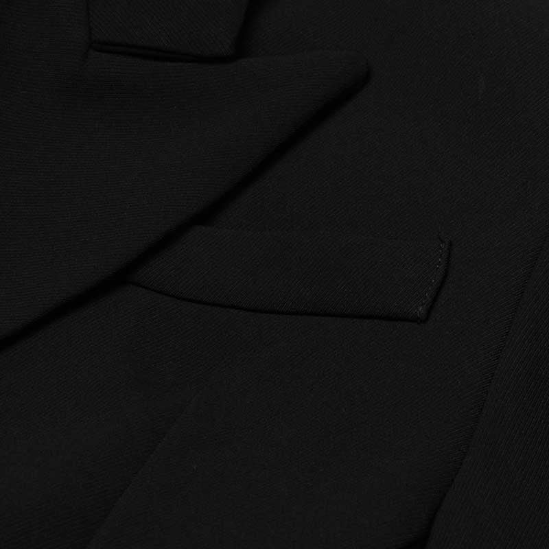 Close-up of women's black maxi blazer coat showing premium fabric and sleek design features