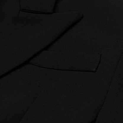 Close-up of women's black maxi blazer coat showing premium fabric and sleek design features