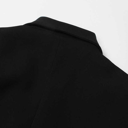 Back view of a women's black maxi blazer coat with a sleek collar design