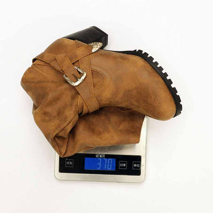 Stylish tan women's block heel knee high boots with buckle detail on a weighing scale