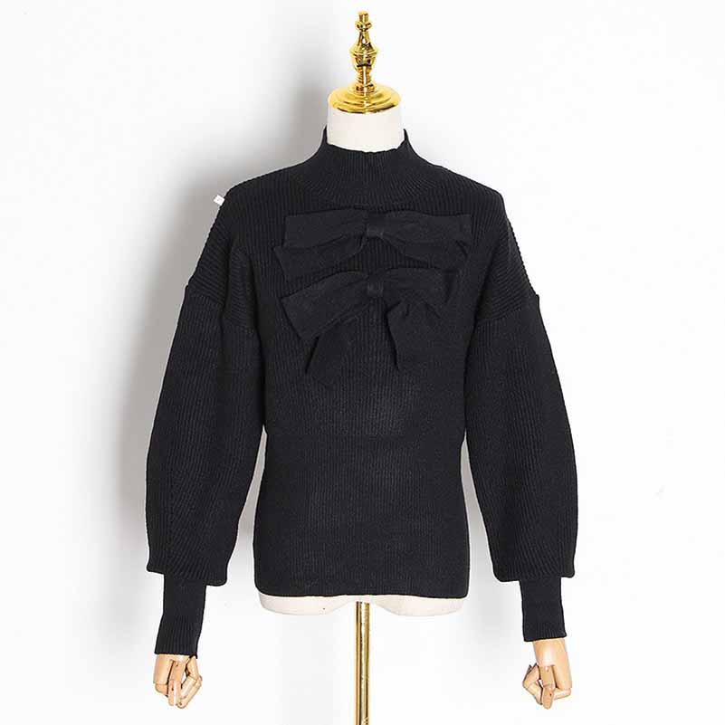 Stylish women's bow detail sweater in black with unique bow accents and puff sleeves