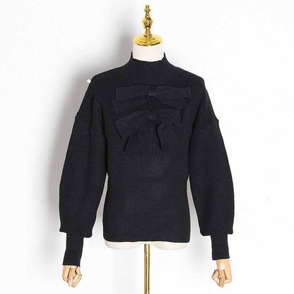Stylish women's bow detail sweater in black with unique bow accents and puff sleeves