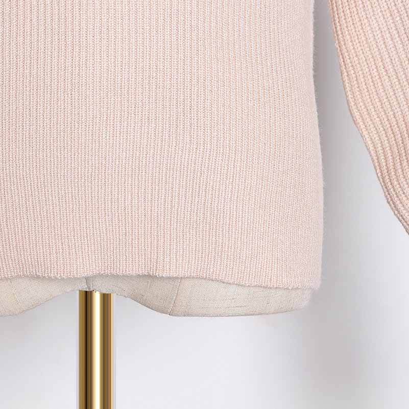 Soft pink women's bow detail sweater featuring a ribbed texture for a stylish look