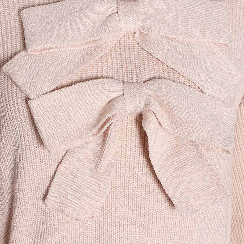 Close-up of women's bow detail sweater in light pink featuring stylish bow accents