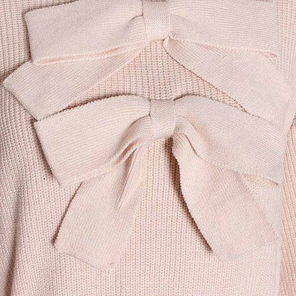 Close-up of women's bow detail sweater in light pink featuring stylish bow accents