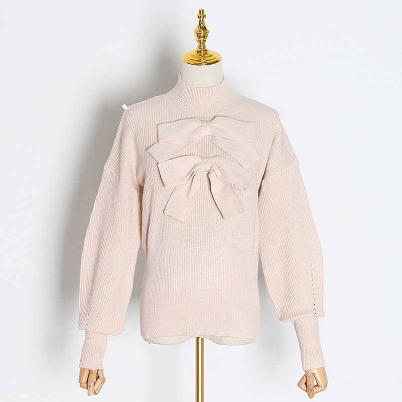 Light pink women's bow detail sweater featuring oversized bow accents on the front