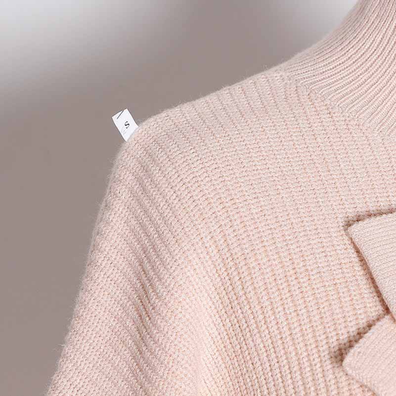 Soft pink women's bow detail sweater with a cozy texture and stylish design