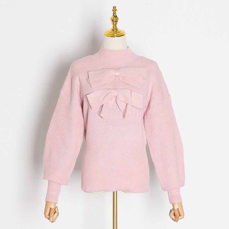 Women's bow detail sweater in soft pink with large bow accents on the front and stylish balloon sleeves
