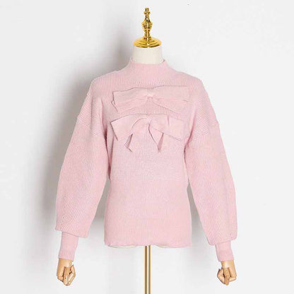 Women's bow detail sweater in soft pink with large bow accents on the front and stylish balloon sleeves