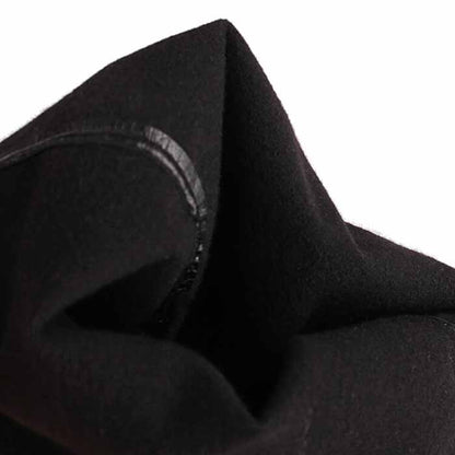 Close-up of women's chunky heel over the knee boots showcasing soft black fabric and sleek design