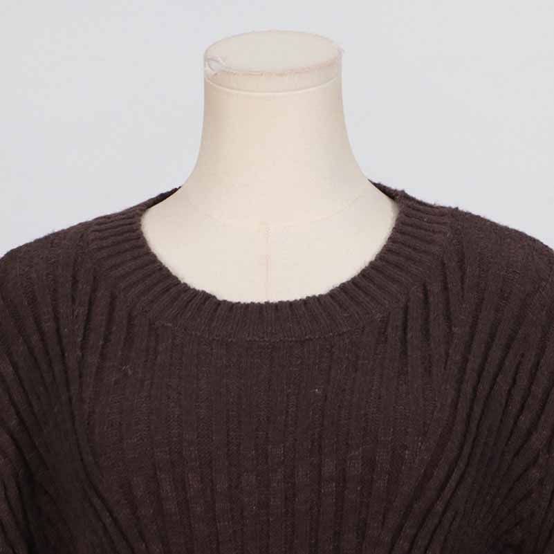 Close-up of a women's cozy knit mini dress in dark brown with a wide neckline