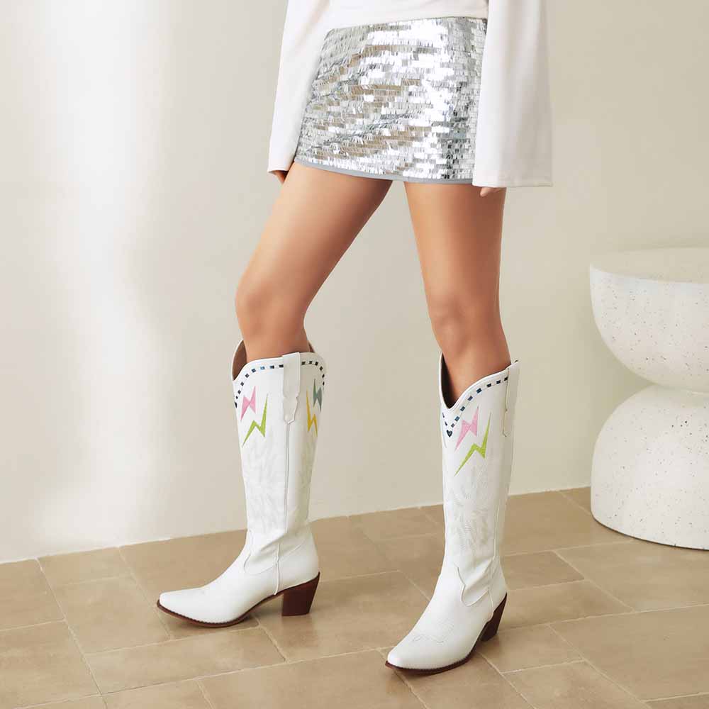 Stylish women's embroidered cowboy boots in white with colorful designs, perfect for trendy outfits.