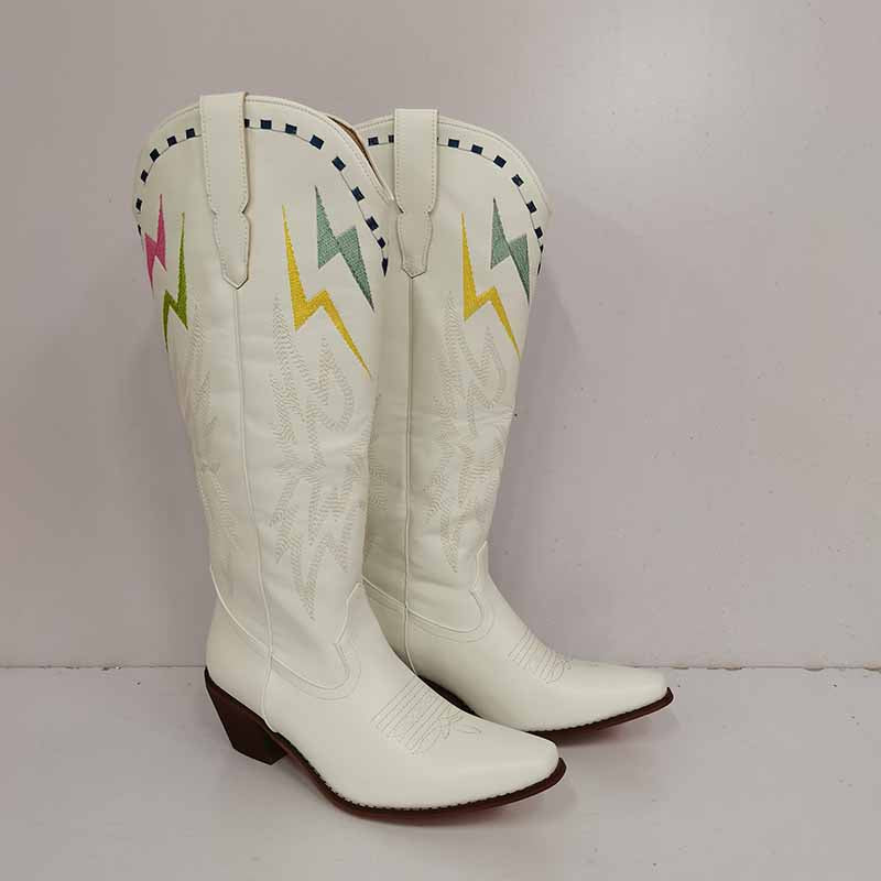 White women's embroidered cowboy boots with colorful designs and a pointed toe for stylish western wear