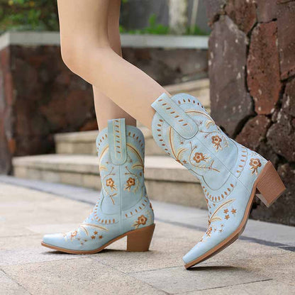 Women's embroidered cowgirl boots in light blue with floral designs and stacked heels