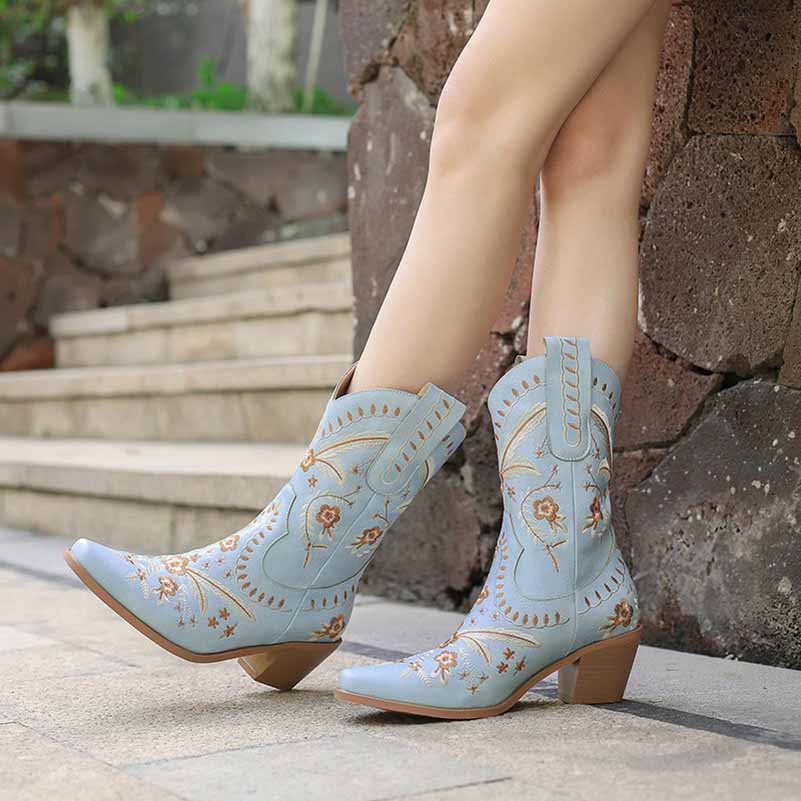 Women's embroidered cowgirl boots in light blue with floral designs and a stylish heel