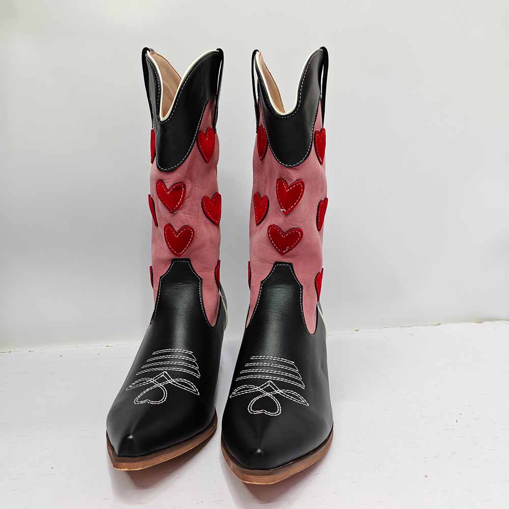 Black and pink women's embroidered cowgirl boots with red heart designs and pointed toes