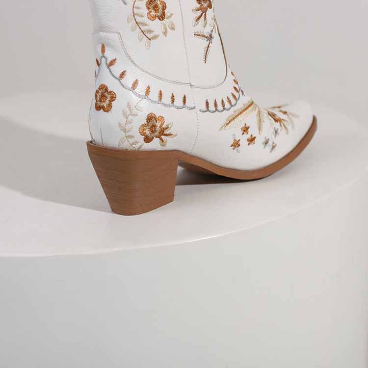 Stylish women's embroidered cowgirl boots in white with floral designs and a comfortable heel