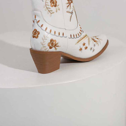 Stylish women's embroidered cowgirl boots in white with floral designs and a comfortable heel