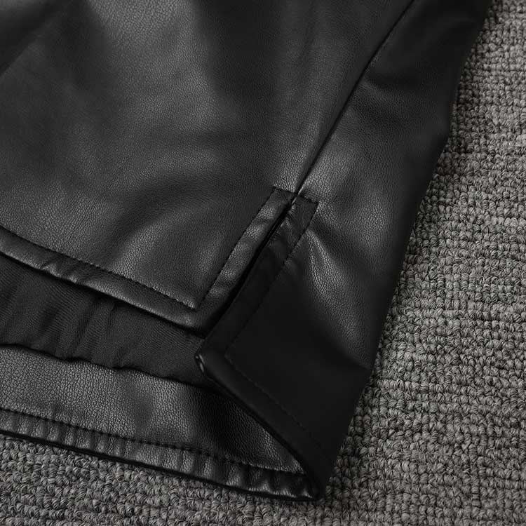 Close-up of the hem detailing on a women's faux leather biker jacket for stylish layering