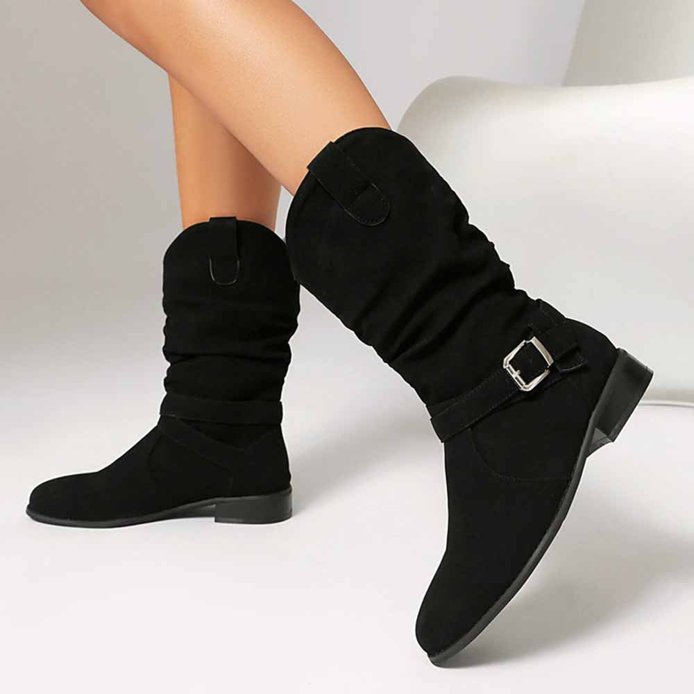 Stylish women's flat suede ankle boots in black with slouchy design and buckle detail