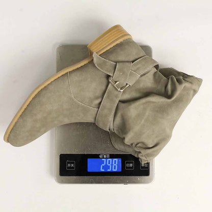 Women's flat suede ankle boots in gray displayed on a digital scale showing weight