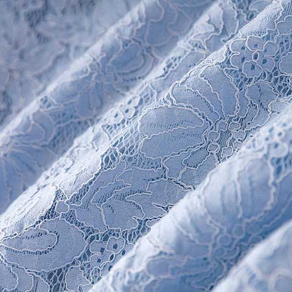 Close-up of delicate blue lace texture for women's formal lace pantsuit for wedding