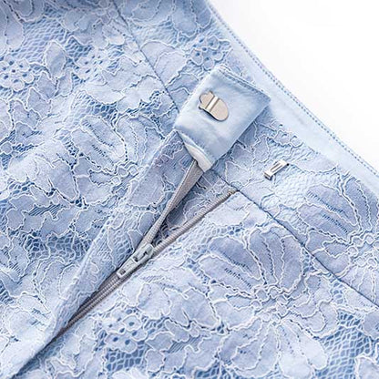 Close-up of a light blue zipper detail on a women's formal lace pantsuit for wedding