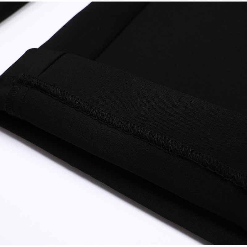 Close-up of women's formal shorts set showing sleek black fabric and neat stitching details