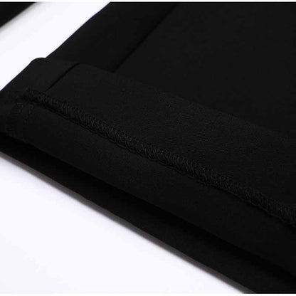 Close-up of women's formal shorts set showing sleek black fabric and neat stitching details