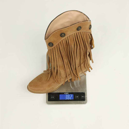 Women's fringe cowgirl boots in tan color displayed on a scale, showcasing stylish design and details